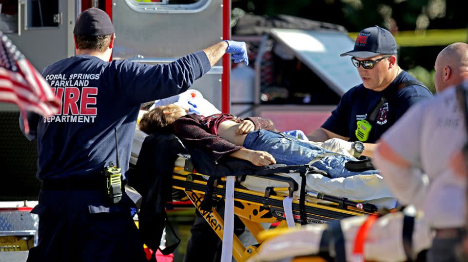 A woman is rushed from the school by paramedics. Source: Getty