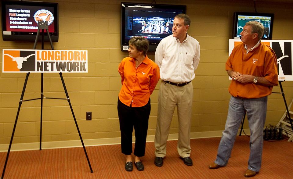 Texas athletic directors Chris Plonsky and DeLoss Dodds, both in orange, show Burke Magnus, ESPN's senior vice president of college sports programming, around the Longhorn Network studio during a press conference on April 3, 2011. The 24-hour network was the first of its kind.