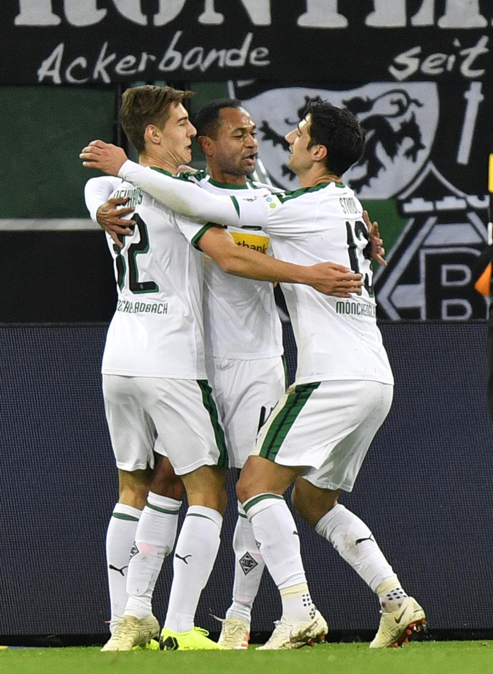 Moenchengladbach's Raffael celebrates with Moenchengladbach's Florian Neuhaus, left, and Moenchengladbach's Lars Stindl, right, after scoring the opening goal during the German Bundesliga soccer match between Borussia Moenchengladbach and VfB Stuttgart in Moenchengladbach, Germany, Sunday, Dec. 9, 2018. (AP Photo/Martin Meissner)
