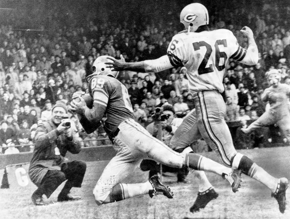 Gail Cogdill of the Detroit Lions catches a 27-yard touchdown pass from quarterback Milt Plum in front of Green Bay packers cornerback Herb Adderly on Thanksgiving Day in Detroit in 1962.