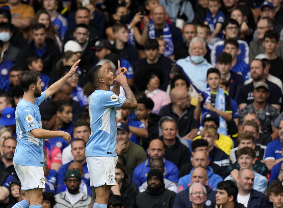 Manchester City's Gabriel Jesus, right, celebrates with Manchester City's Bernardo Silva after scoring his side's opening goal during the English Premier League soccer match between Chelsea and Manchester City at Stamford Bridge Stadium in London, Saturday, Sept. 25, 2021. (AP Photo/Alastair Grant)