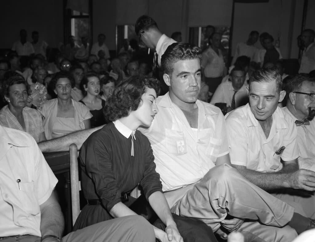 In this Sept. 22. 1955 photo, Carolyn Bryant rests her head on her husband Roy Bryant’s shoulder after she testified in Emmett Till murder court case in Sumner, Miss. (AP Photo, File)