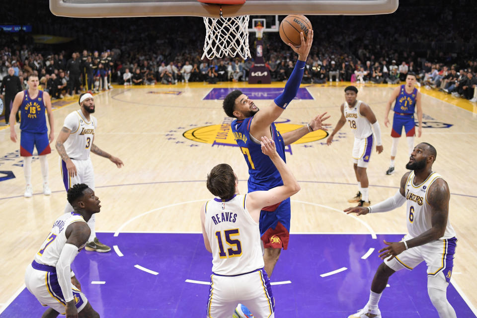Denver Nuggets guard Jamal Murray, top, shoots over Los Angeles Lakers guard Austin Reaves (15) in the second half of Game 3 of the NBA basketball Western Conference Final series Saturday, May 20, 2023, in Los Angeles. (AP Photo/Mark J. Terrill)