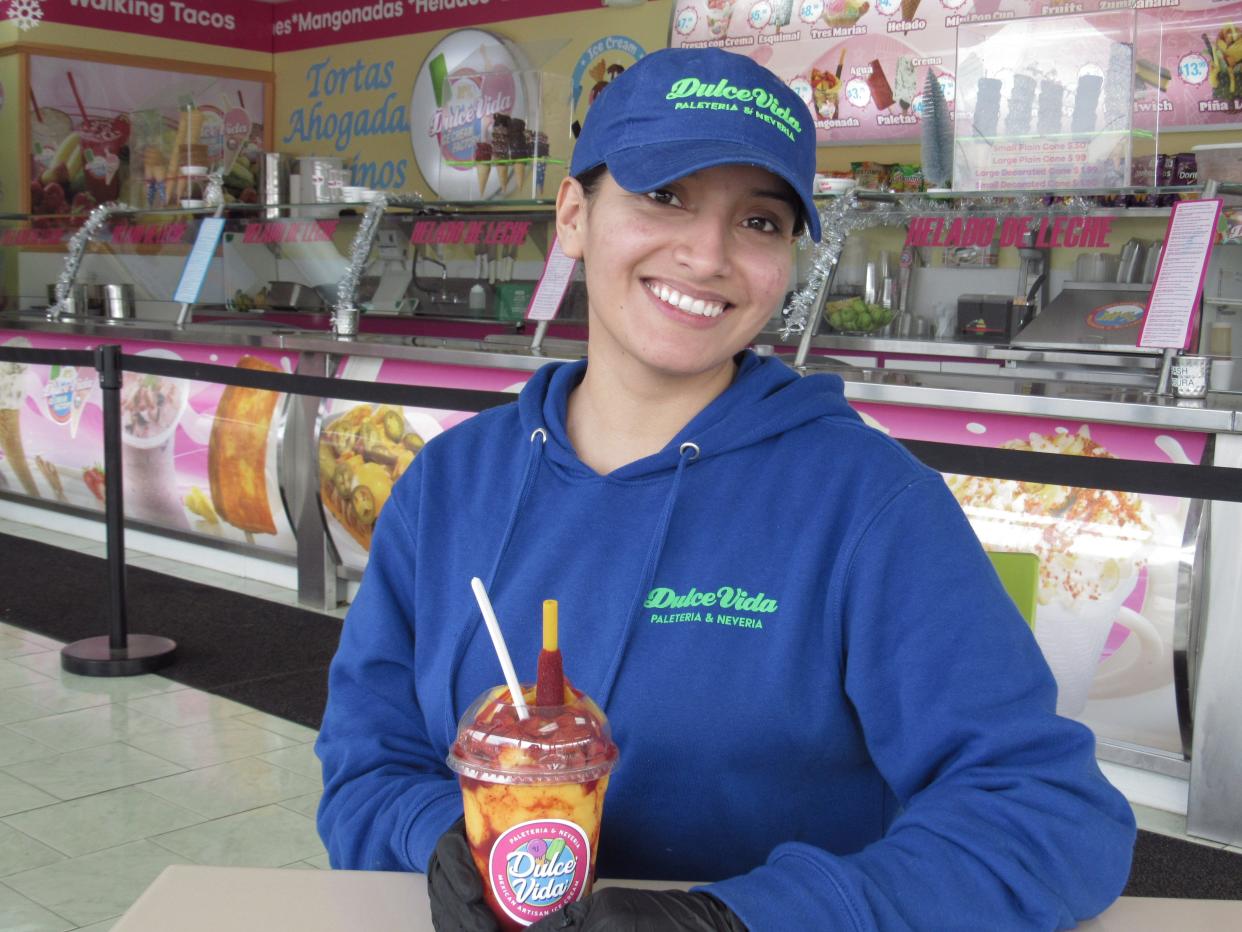 Diana Medina displays a mangonada at Dulce Vida Ice Cream Factory, 2400 Home Acre Drive in Northland. The Mexican ice cream shop is moving into a building just to the north, at 6144 Cleveland Ave., where it will roughly double in size.