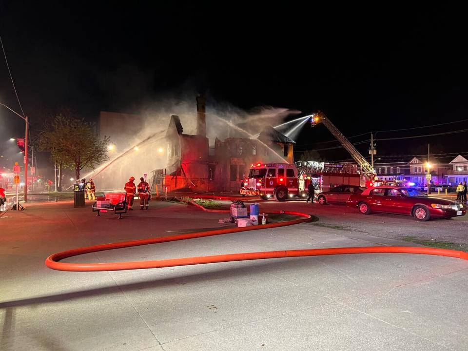 Aerial trucks shoot water at 841 Ouellette Avenue.