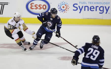 May 20, 2018; Winnipeg, Manitoba, CAN; Winnipeg Jets left wing Nikolaj Ehlers (27) chases the puck with Vegas Golden Knights left wing David Perron (57) in the second period in game five of the Western Conference Final of the 2018 Stanley Cup Playoffs at Bell MTS Centre. Mandatory Credit: James Carey Lauder-USA TODAY Sports