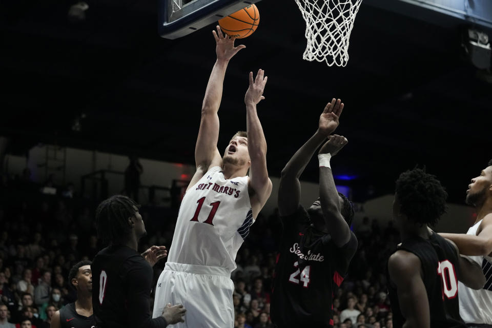 Saint Mary's center Mitchell Saxen (11) rebounds the ball next to Cal State Stanislaus forward Daniel Ameyaw (24) during the first half of an NCAA college basketball game Monday, Nov. 6, 2023, in Moraga, Calif. (AP Photo/Godofredo A. Vásquez)