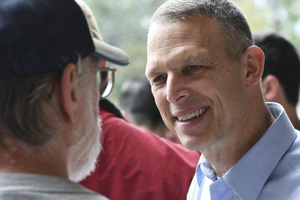 In this Oct. 6, 2018 photo, Republican U.S. Rep. Scott Perry of Pennsylvania speaks to a party committeeman at a rally with volunteer canvassers, in Harrisburg, Pa. A court-ordered redrawing of Pennsylvania's House districts has forced several Republican congressmen, including Perry, into more competitive seats and helped establish Pennsylvania as a key state for Democrats aiming to recapture the House majority. (AP Photo/Marc Levy)