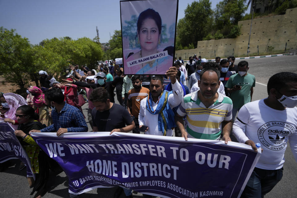 Employees of Jammu and Kashmir Teachers Association shout slogans during a protest against the killing of colleague Rajini Bala in Jammu, India, Thursday, June 2, 2022. After that killing, Hindu government employees staged protests in several areas, demanding the government relocate them from Kashmir to safer areas in the Hindu-dominated Jammu region. In another incident, assailants fatally shot a Hindu bank manager in Indian-controlled Kashmir on Thursday, said police, who blamed militants fighting against Indian rule for the attack. (AP Photo/Channi Anand)