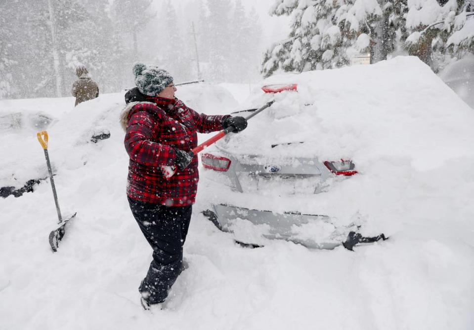 Janna Gunnels digs out her car along North Lake Boulevard as snow continues to fall in Tahoe City on Saturday, March 2, 2024.