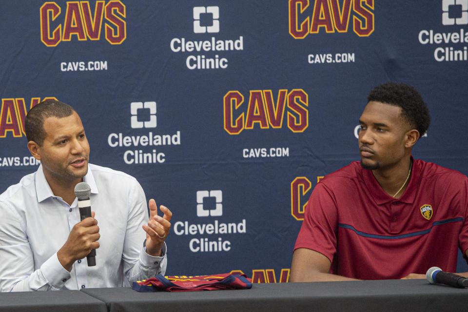 Cleveland Cavaliers first-round draft selection, Evan Mobley, right, listens to Cavaliers GM Koby Altman during a news conference at the NBA basketball team's training facility in Independence, Ohio, Friday, July 30, 2021. (AP Photo/Phil Long)