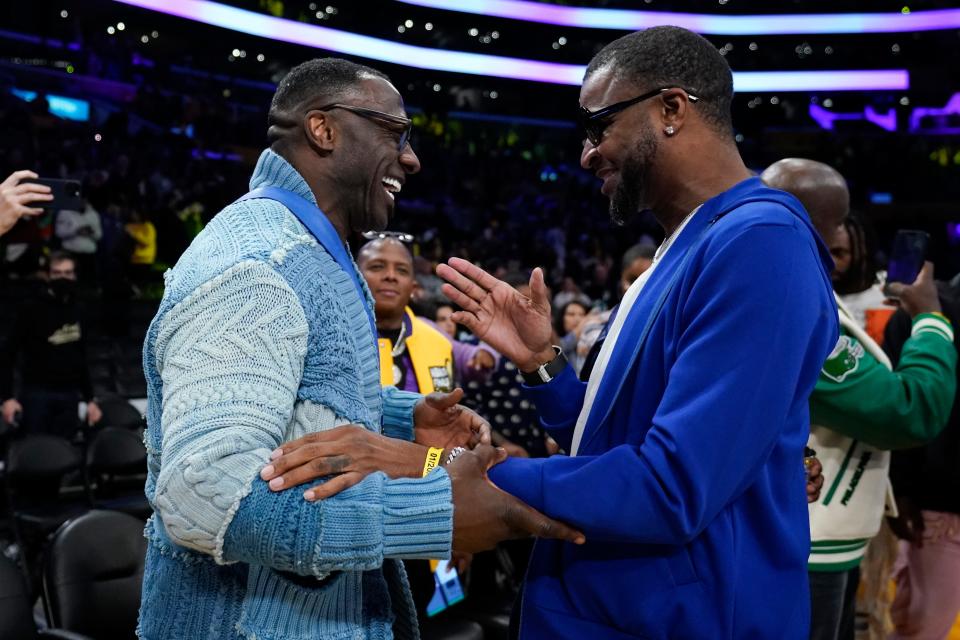 Former NFL player Shannon Sharpe, left, talks with Tee Morant, father of Memphis Grizzlies guard Ja Morant, after an NBA basketball game against the Los Angeles Lakers in Los Angeles, Friday, Jan. 20, 2023. At halftime, Sharpe confronted Memphis Grizzlies forward Dillon Brooks and center Steven Adams. (AP Photo/Ashley Landis)