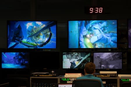 A control room full of video screens keeping watch over the underwater training at NASA's Neutral Buoyancy Laboratory (NBL) training facility near the Johnson Space Center in Houston,