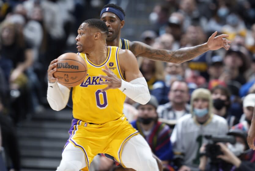 Los Angeles Lakers guard Russell Westbrook, front, looks to pass the ball as Denver Nuggets forward Will Barton.