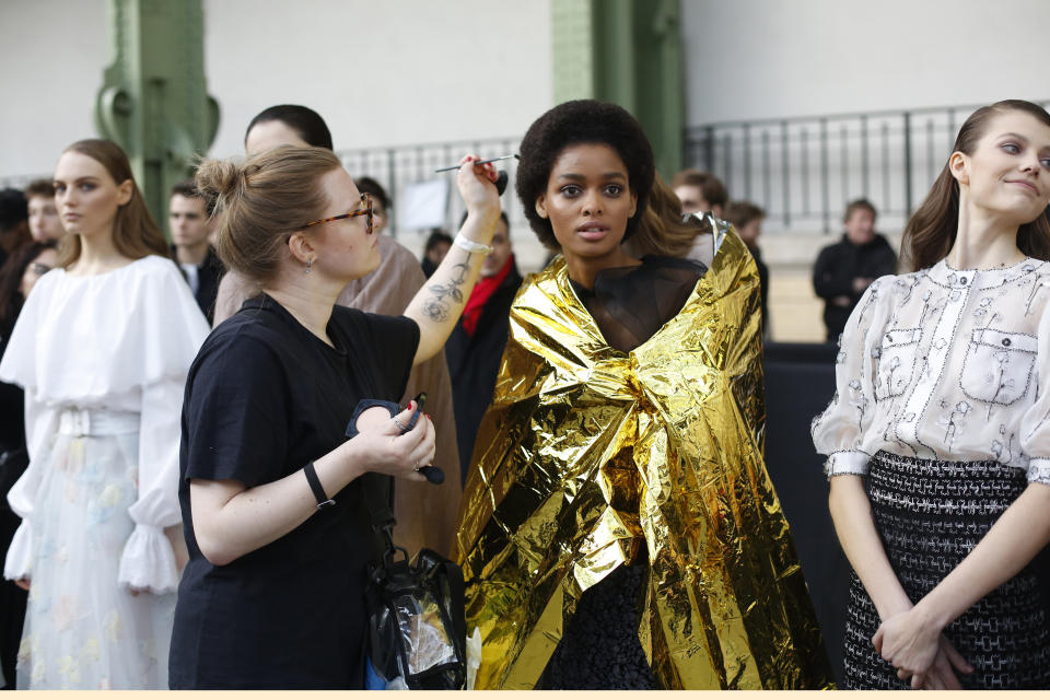 A model is being made up before the prsentation of Chanel Haute Couture Spring/Summer 2020 fashion collection, Tuesday Jan.21, 2020 in Paris. (AP Photo/Thibault Camus)