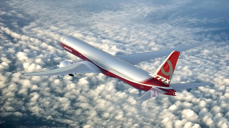 A rendering of a 777-9 flying above clouds.