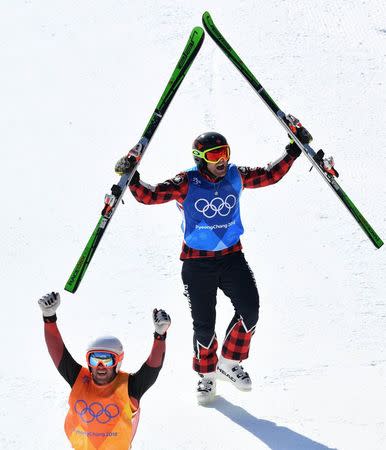 Freestyle Skiing - Pyeongchang 2018 Winter Olympics - Men's Ski Cross Finals - Phoenix Snow Park - Pyeongchang, South Korea - February 21, 2018 - Silver medallist Marc Bischofberger of Switzerland and gold medallist Brady Leman of Canada celebrate. REUTERS/Dylan Martinez