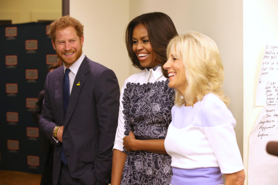 Prince Harry, first lady Michelle Obama, and Jill Biden tour the USO Warrior and Family Center at the Fort Belvoir military base. 