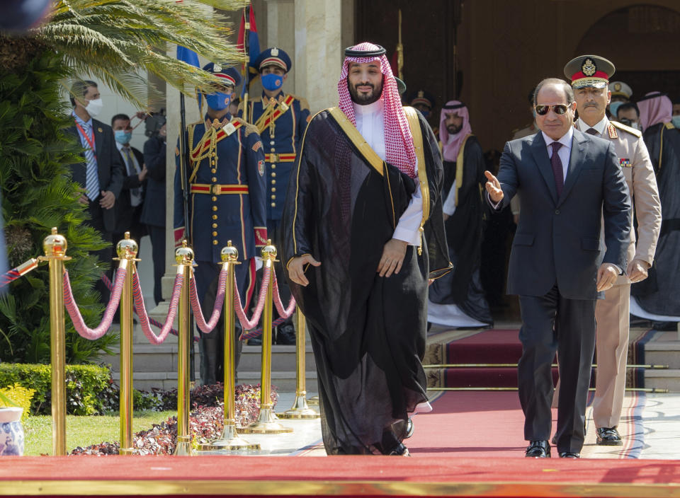In this photo released by the Saudi Royal Palace, Saudi Crown Prince Mohammed bin Salman, left, and Egyptian President Abdel-Fattah el-Sissi review an honor guard, in Cairo, Egypt, Tuesday, June 21, 2022. (Bandar Aljaloud/Saudi Royal Palace via AP)