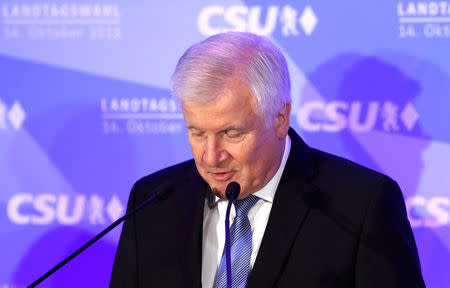 Leader of the Christian Social Union (CSU) Horst Seehofer gives a speech after first exit polls in the Bavarian state election in Munich, Germany, October 14, 2018. REUTERS/Michaela Rehle