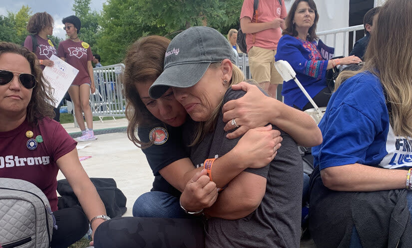 Members of the Parkland, Florida, community hug after hitting the ground because of a threat at the March for Our Lives rally in Washington, D.C., June 11. (Mark Keierleber/The74)