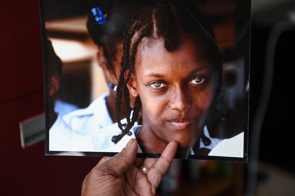 Alex Hicks Jr., photo editor of Gannett's SC publications, the News, Herald-Journal and Independent Mail, holds a photo he made of a school girl in Grenada, an island in the Caribbean, during his time as a Navy photographer, in his home in Spartanburg, SC, on Wednesday, Nov. 8, 2023.