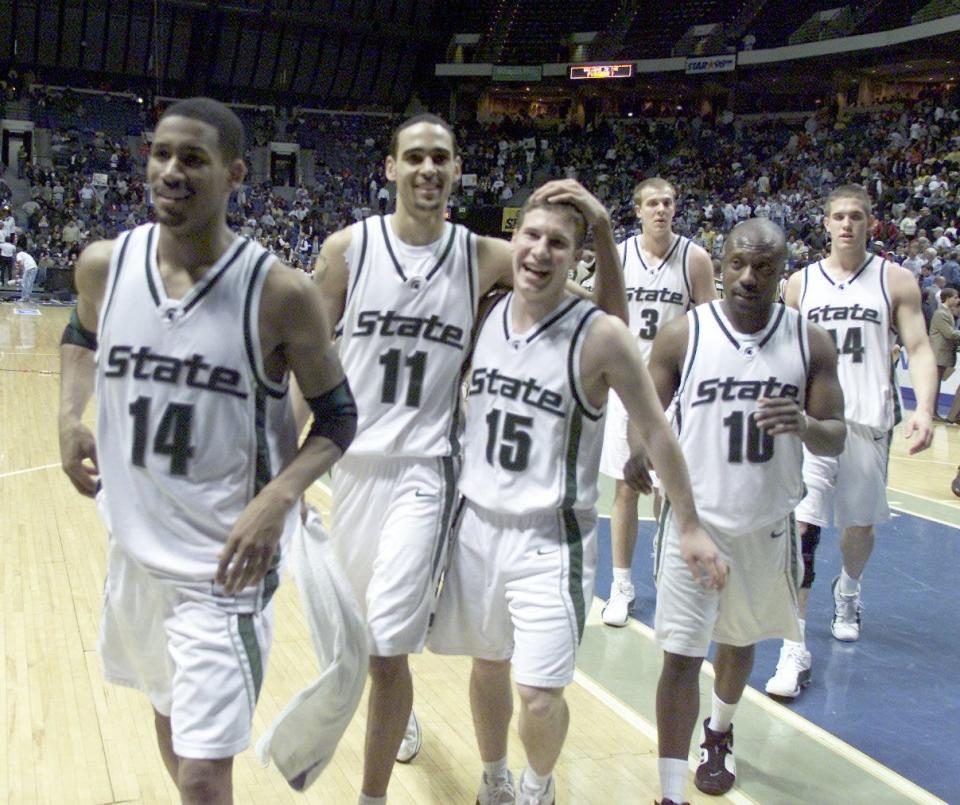 Michigan State University's (14) Charlie Bell leads the team off the floor as  (11) David Thomas hugs (15) Mat Ishbia after their 69-35 win over   Alabama State in the 1st Round of the South Region of the NCAA Men's Basketball Tournament in Memphis, TN on Mar 16, 2001. (10) is Brandon Smith.