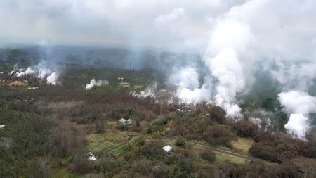 Molten rock flows and burst to the surface, threatening homes in a rural area in this still image from an aerial video taken from a Hawaii Army National Guard a week after the eruption of the Kilauea volcano, in Pahoa, Hawaii, U.S., May 10, 2018. Courtesy Andrew Jackson/Hawaii DoD/Handout via REUTERS