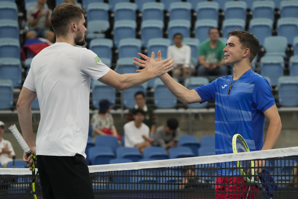 Dalibor Svrcina, right, of the Czech Republic congratulates Germany's Oscar Otte following their Group C match at the United Cup tennis event in Sydney, Australia, Sunday, Jan. 1, 2023. (AP Photo/Mark Baker)