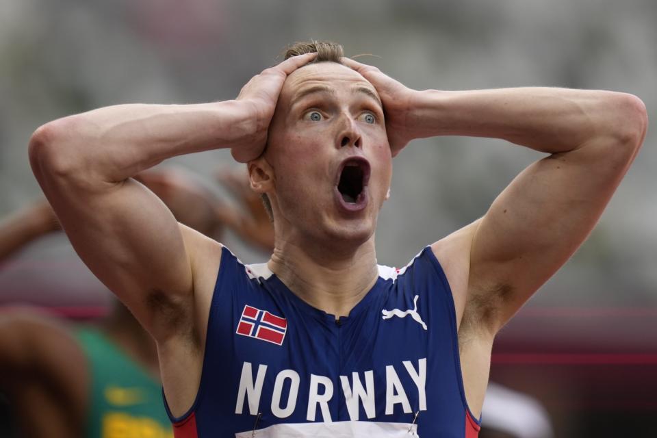 Karsten Warholm reacts after setting a world record and winning gold in the men's 400-meter hurdles at the Tokyo Olympics.