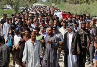 Mourners chant slogans against the al-Qaida breakaway group Islamic State of Iraq and the Levant (ISIL), while carrying a flag-draped coffin of Ammar Tueni, 24, a policeman killed in a car bomb attack during his funeral procession in Hillah, about 60 miles (95 kilometers) south of Baghdad, Iraq, Thursday, April 24, 2014. The Shiite-dominated city of Hillah has seen sporadic violence recently. Last month, a suicide car bomber hit another checkpoint in same area, killing 36 people. Iraq has seen a spike in violence since last year, with the death toll climbing to its highest levels since the worst of the country's sectarian bloodletting between 2006 and 2008. The U.N. says 8,868 people were killed in 2013, and more than 1,400 people were killed in the first two months of this year. (AP Photo/Karim Kadim)