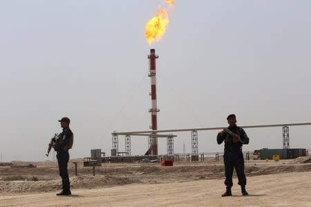 FILE PHOTO: Members of the oil police guard near the West Qurna-1 oilfield, which is operated by ExxonMobil, near Basra