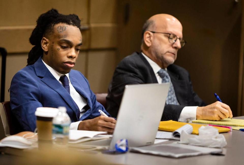 Jamell Maurice Demons, known professionally as YNW Melly, left and attorney Stuart Adelstein, a member of his defense team, take notes during opening statements at the rapper’s double murder trial on Monday, June 9, 2023, in a Fort Lauderdale court.