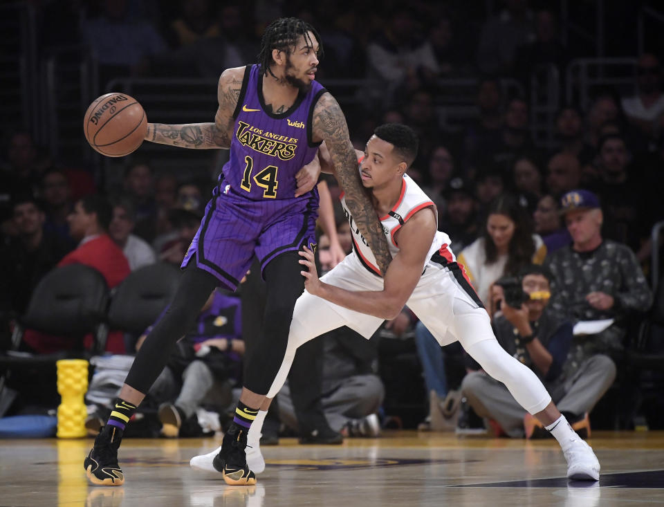 Los Angeles Lakers forward Brandon Ingram, left, tries to get by Portland Trail Blazers guard CJ McCollum during the first half of an NBA basketball game Wednesday, Nov. 14, 2018, in Los Angeles. (AP Photo/Mark J. Terrill)