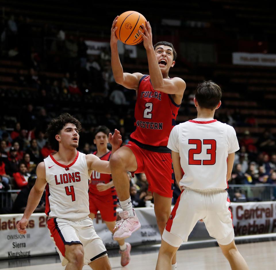 Tulare Western's Malachi Ficher drives against Kerman during their Central Section Division IV Boys Championship game at Selling Arena in Fresno, Calif., Friday, Feb. 24, 2023.