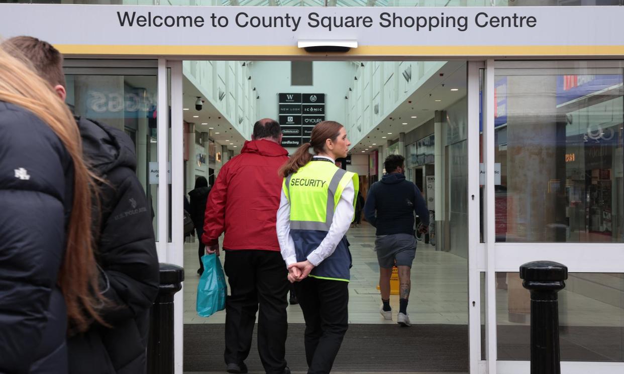 <span>A security worker wearing a stab vest at County Square shopping centre in Ashford, Kent.</span><span>Photograph: Martin Godwin/The Guardian</span>