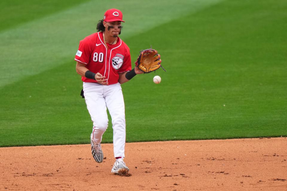 Cincinnati Reds shortstop Edwin Arroyo (80) fields a groundball in the eighth inning during a MLB spring training baseball game, Monday, Feb. 26, 2024, at Goodyear Ballpark in Goodyear, Ariz.