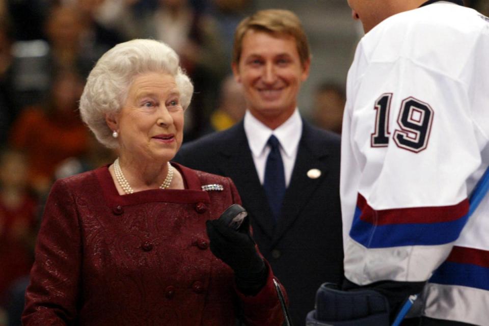 Queen Elizabeth talks to Vancouver Canucks captain Markus Naslund after she receieved the ceremonial puck prior to the Canucks preseason game against the San Jose Sharks, in Vancouver, Canada. (AFP via Getty Images)