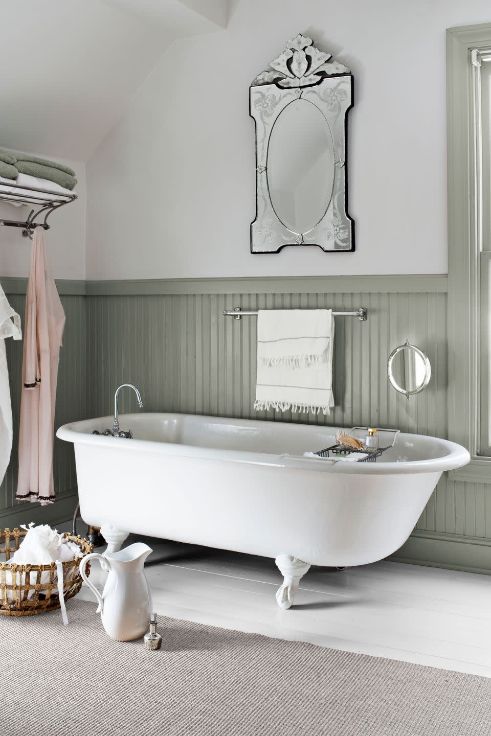 bathroom with white clawfoot tub and gray green wainscotting