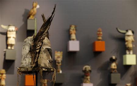 An antique tribal mask, Tumas Crow Mother (L), circa 1860-1870, revered as a sacred ritual artifact by the Native American Hopi tribe in Arizona, is displayed at the Drouot auction house ahead of a sale in Paris December 9, 2013. REUTERS/Christian Hartmann