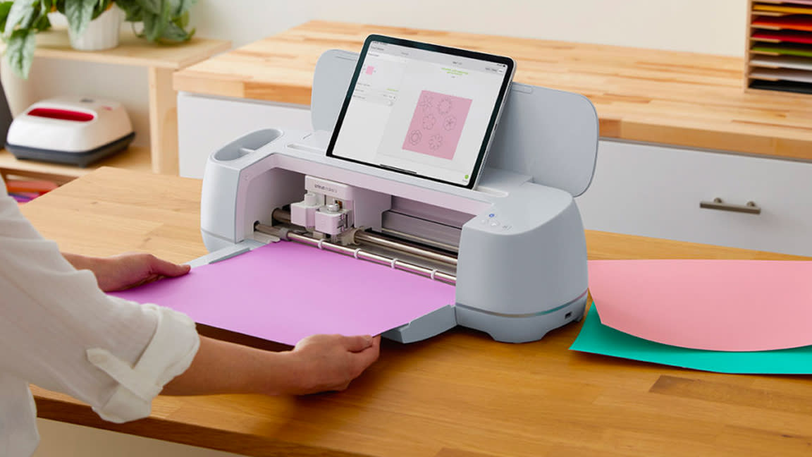  How to use a Cricut; a person uses a Cricut craft machine. 