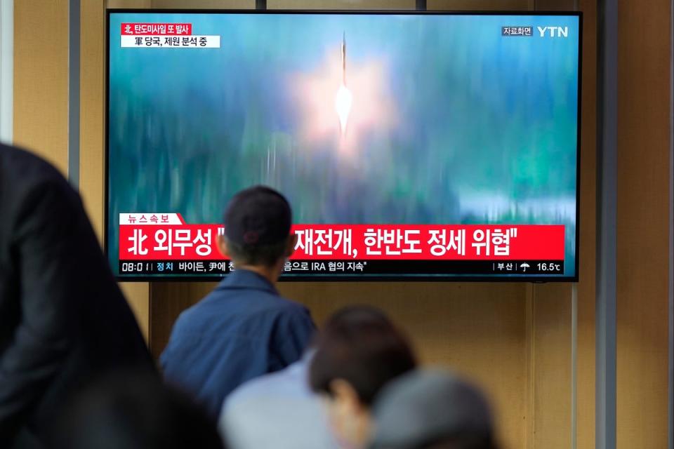 A TV screen showing a news programme reporting about North Korea’s missile launch (AP)