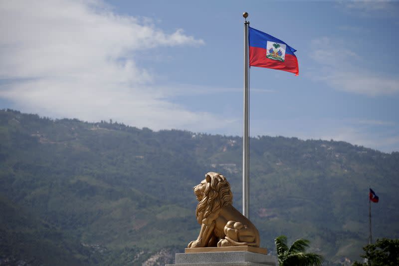 FILE PHOTO: The Haitian flag is seen next to the statue of a lion at the Court of Cassation (Supreme Court) in Port-au-Prince