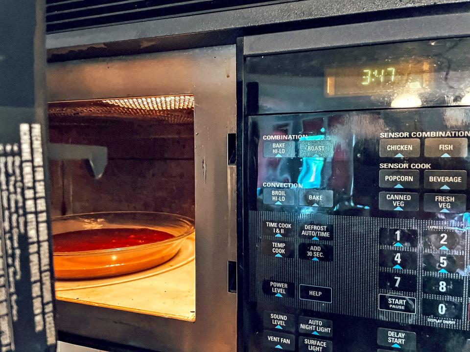 pie pan of brownies inside a microwave