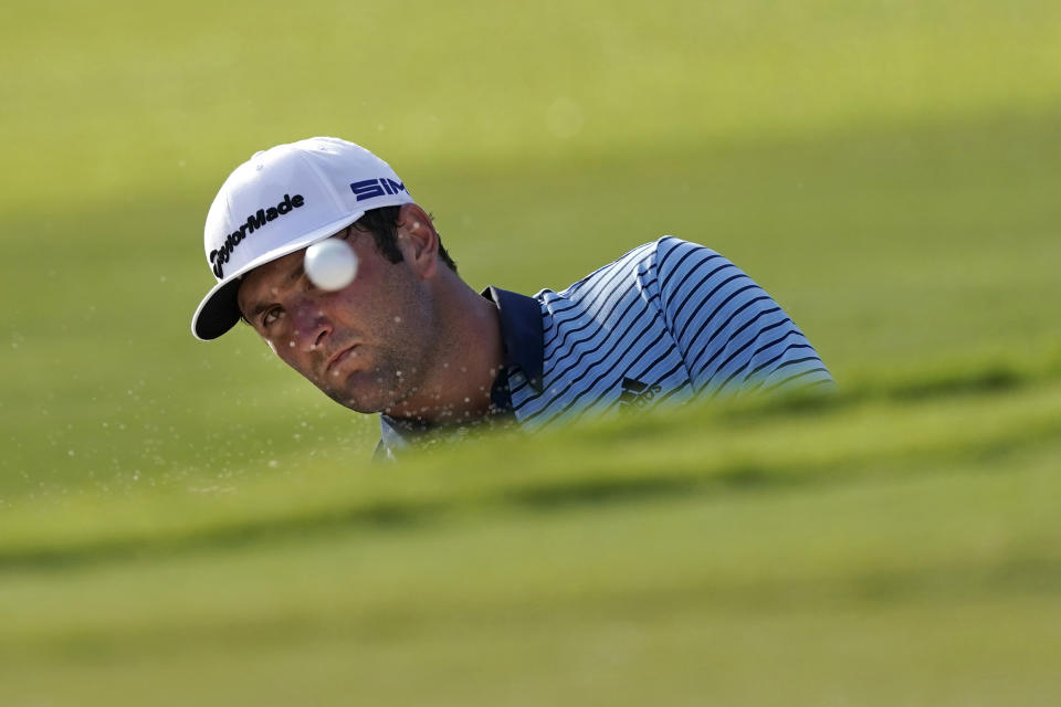 Jon Rahm hits from a greenside bunker on the 18th hole during the first round of the Tour Championship golf tournament at East Lake Golf Club, Friday, Sept. 4, 2020, in Atlanta. (AP Photo/John Bazemore)