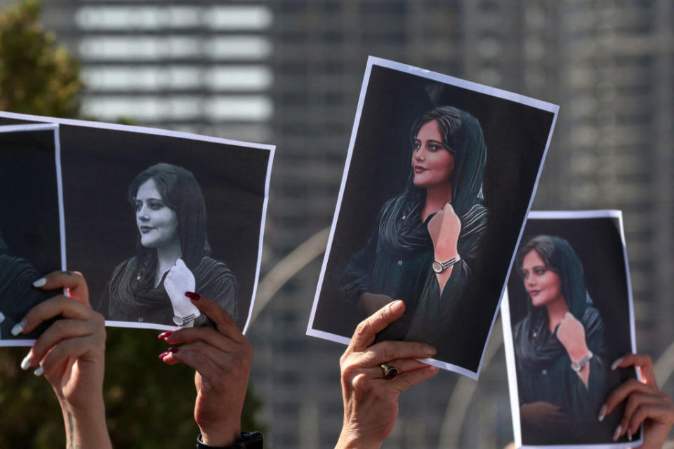 Women hold up signs depicting the image of 22-year-old Mahsa Amini, who died while in the custody of Iranian authorities, during a demonstration denouncing her death by Iraqi and Iranian Kurds outside the U.N. offices in Erbil, the capital of Iraq's autonomous Kurdistan region, on Sept. 24, 2022. Safin Hamed—AFP/Getty Images<span class="copyright">AFP via Getty Images</span>