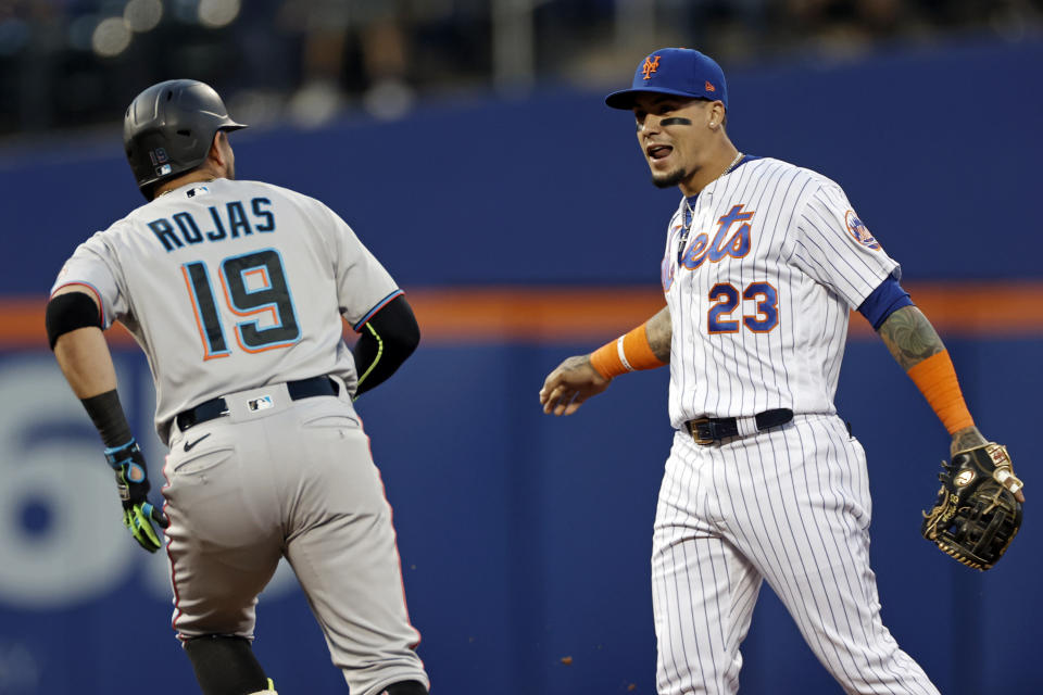 Miami Marlins' Miguel Rojas talks to New York Mets shortstop Javier Baez (23) as he runs the bases after hitting a home run during the first inning of a baseball game Thursday, Sept. 2, 2021, in New York. (AP Photo/Adam Hunger)