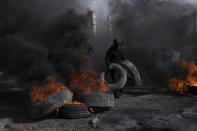 Palestinian protesters block the main road with burning tires in the West Bank city of Jericho, Monday, Feb. 6, 2023. Israeli forces killed five Palestinian gunmen in a raid on a refugee camp in the occupied West Bank on Monday, the latest bloodshed in the region that will likely further exacerbate tensions. (AP Photo/Nasser Nasser)