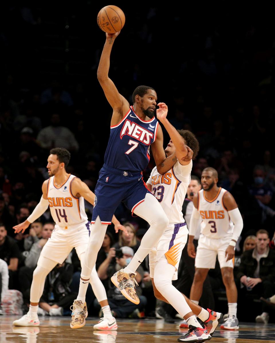 Nov 27, 2021; Brooklyn, New York, USA; Brooklyn Nets forward Kevin Durant (7) controls the ball against Phoenix Suns forward Cameron Johnson (23) during the second quarter at Barclays Center.
