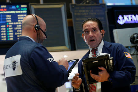 Traders work on the floor of the New York Stock Exchange (NYSE) in New York, U.S., May 22, 2017. REUTERS/Brendan McDermid